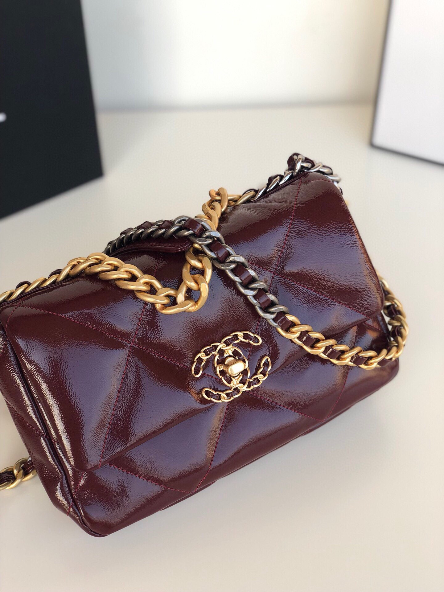 Ch*el 19 handbag shiny leather, gold-tone, silver-tone & ruthenium-finish metal dark red 6.2 × 10.1 × 3.5 in