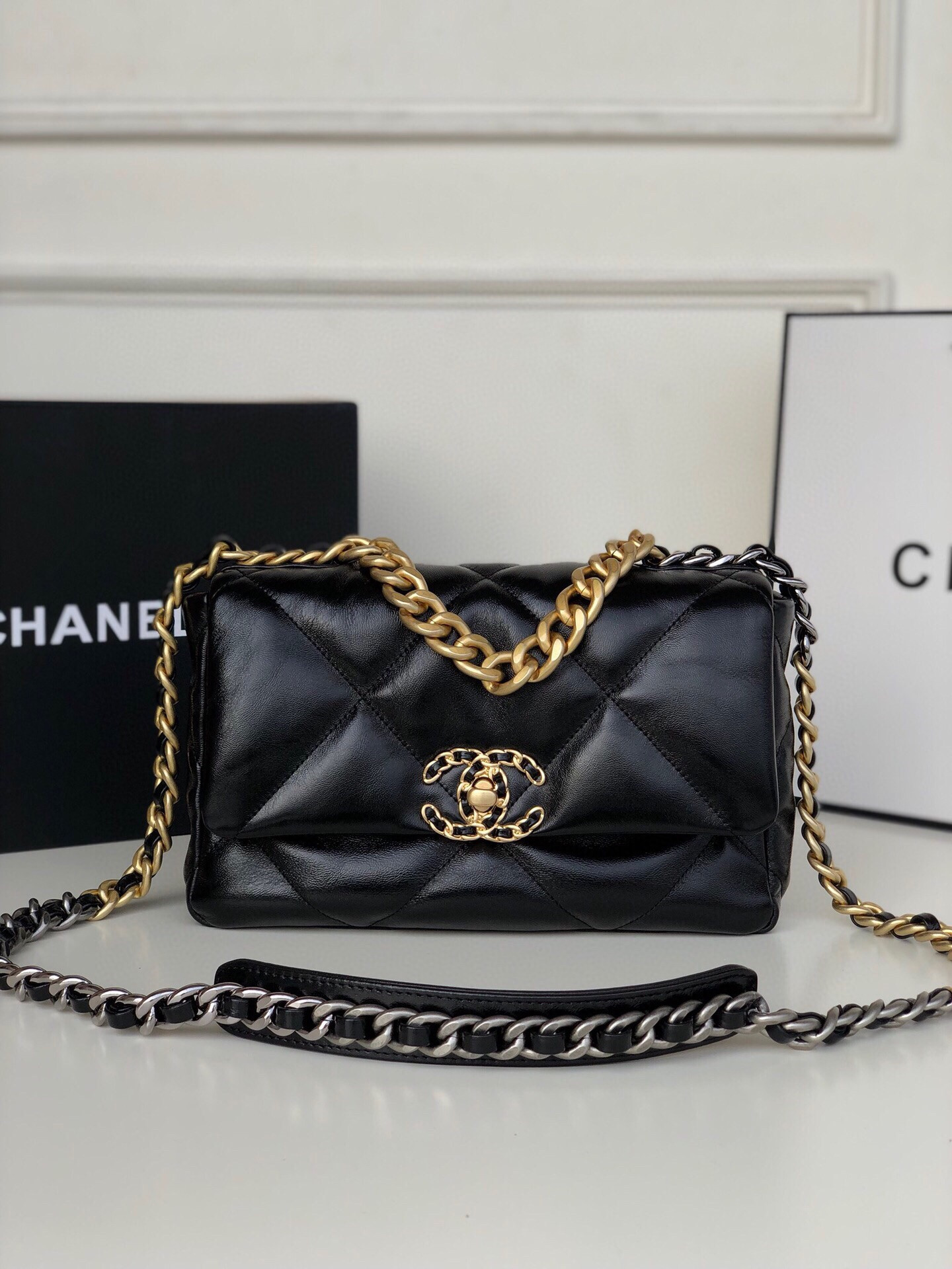 Ch*el 19 handbag shiny leather, gold-tone, silver-tone & ruthenium-finish metal black 6.2 × 10.1 × 3.5 in