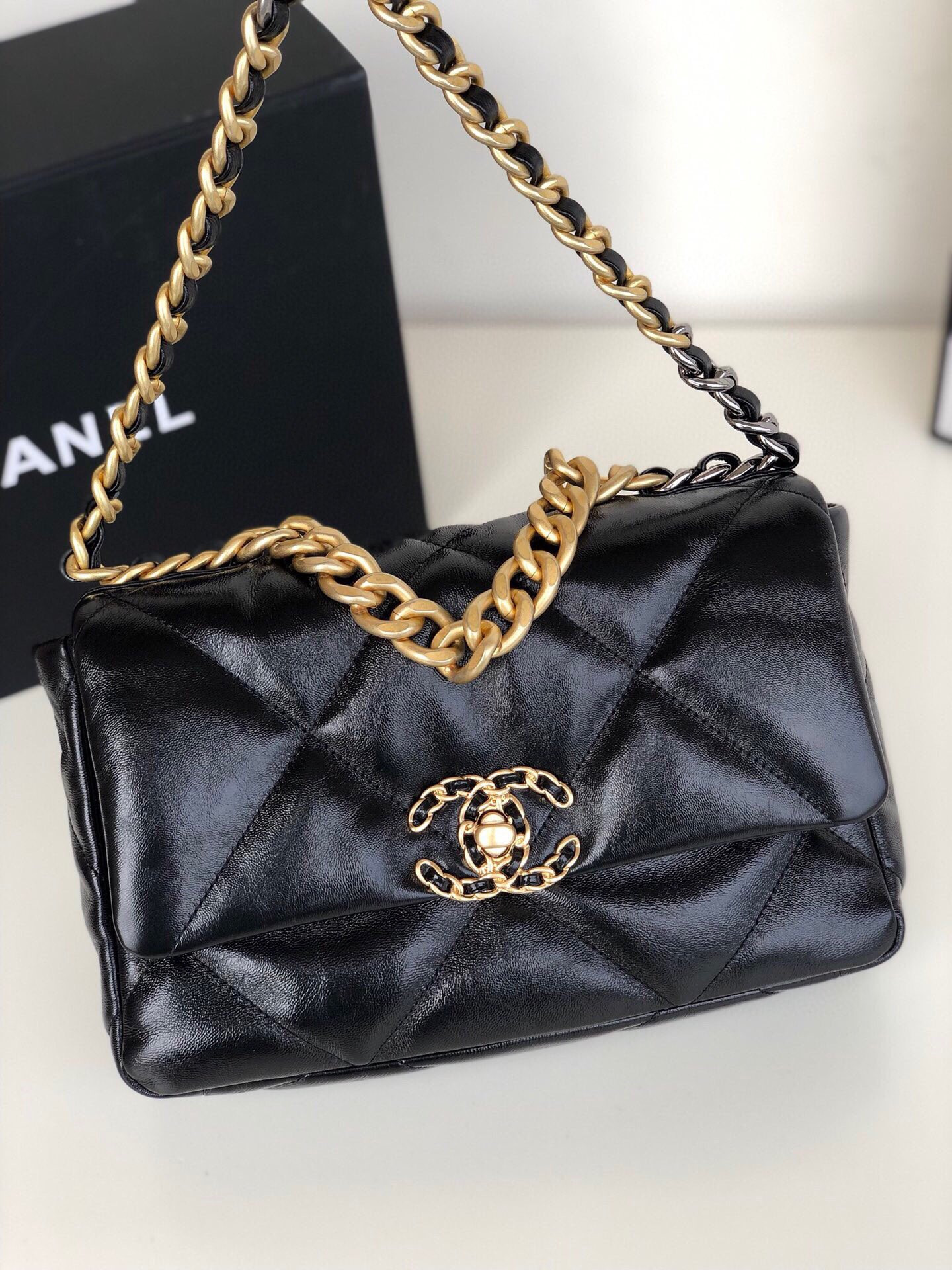 Ch*el 19 handbag shiny leather, gold-tone, silver-tone & ruthenium-finish metal black 6.2 × 10.1 × 3.5 in