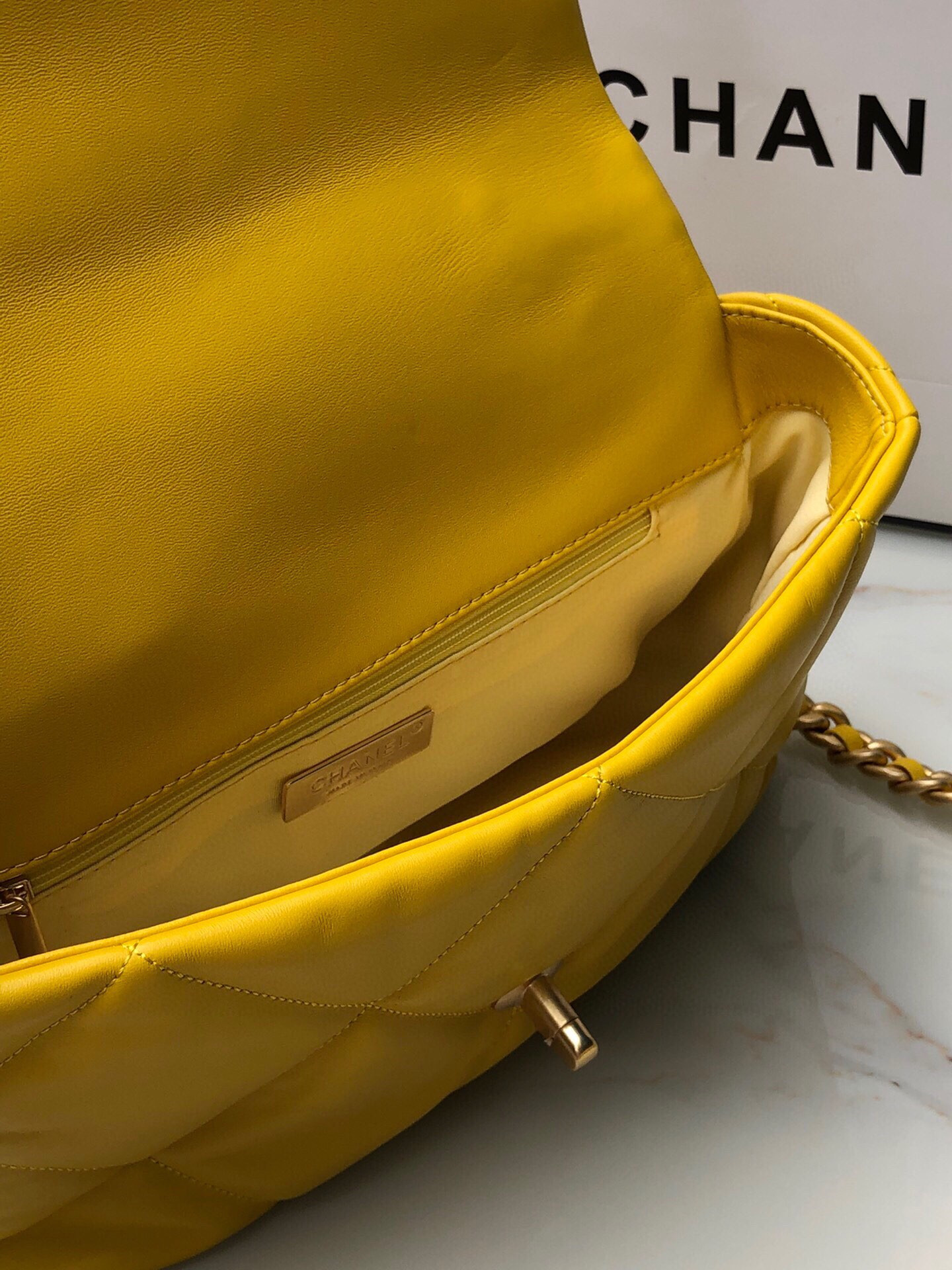 Ch*el 19 large handbag shiny leather, gold-tone, silver-tone & ruthenium-finish metal yellow 7.8 × 11.7 × 3.9 in