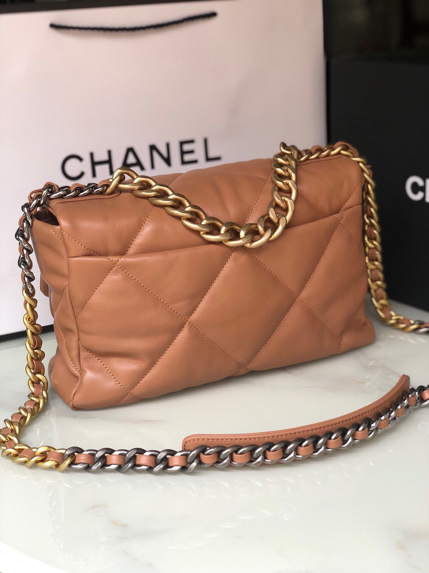 Ch*el 19 large handbag shiny leather, gold-tone, silver-tone & ruthenium-finish metal caramel 7.8 × 11.7 × 3.9 in