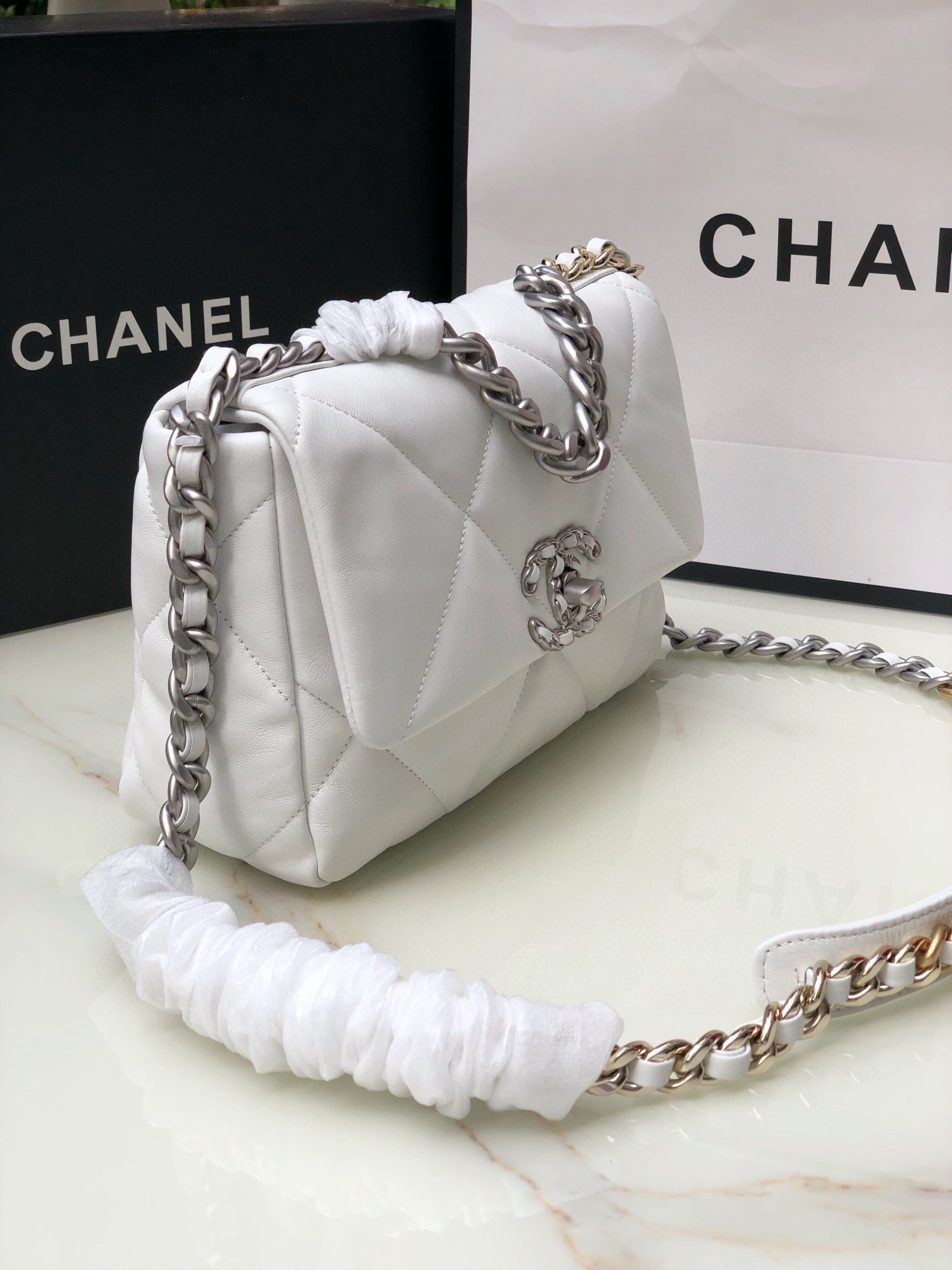 Ch*el 19 handbag shiny leather, gold-tone, silver-tone & ruthenium-finish metal white 6.2 × 10.1 × 3.5 in
